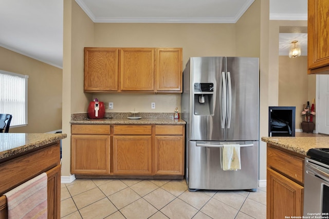 kitchen with light stone counters, crown molding, appliances with stainless steel finishes, and light tile patterned flooring