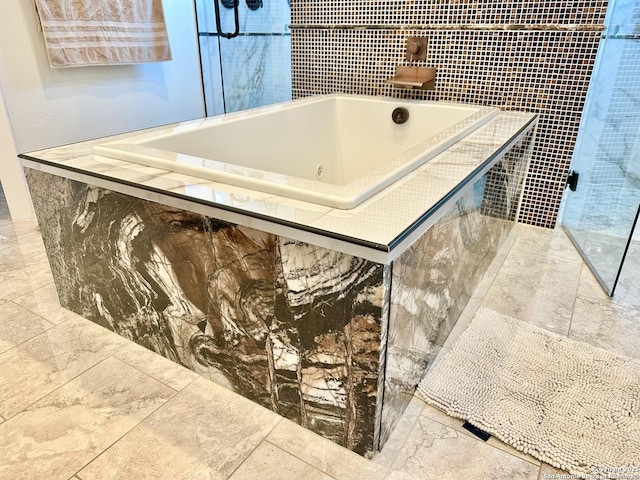 interior space featuring a tub with jets