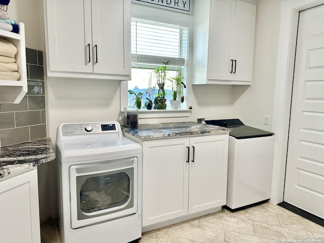 laundry room with washer / dryer and cabinet space