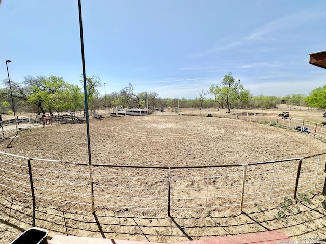 view of home's community with an enclosed area and a rural view
