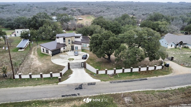 drone / aerial view featuring a wooded view