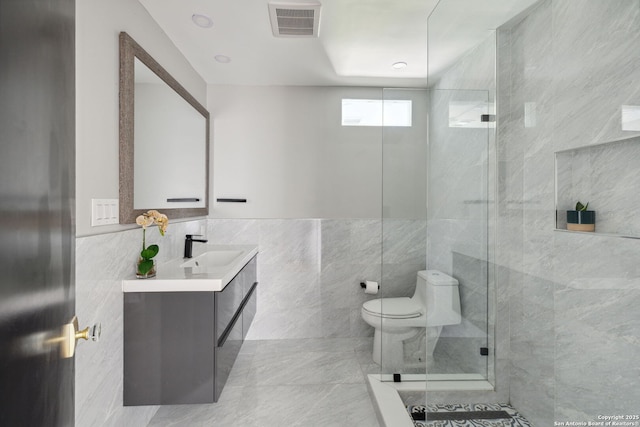 bathroom with visible vents, tile walls, walk in shower, vanity, and toilet
