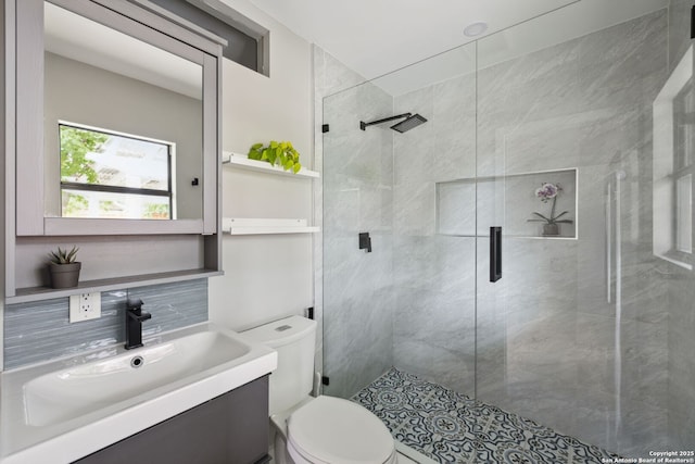 full bathroom with vanity, toilet, and a shower stall