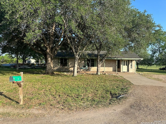 view of front of house with driveway and a front lawn