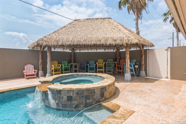 view of swimming pool with fence, a patio, a gazebo, and a pool with connected hot tub