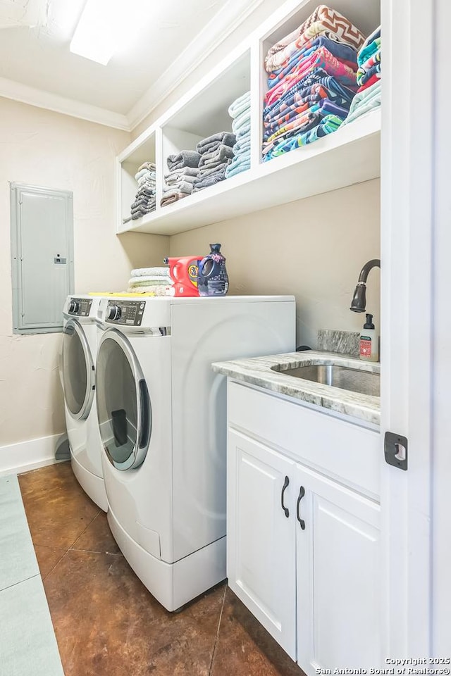 clothes washing area featuring crown molding, washing machine and dryer, dark tile patterned floors, electric panel, and a sink