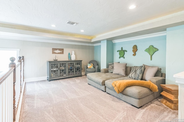 carpeted living room with baseboards, a tray ceiling, recessed lighting, and visible vents