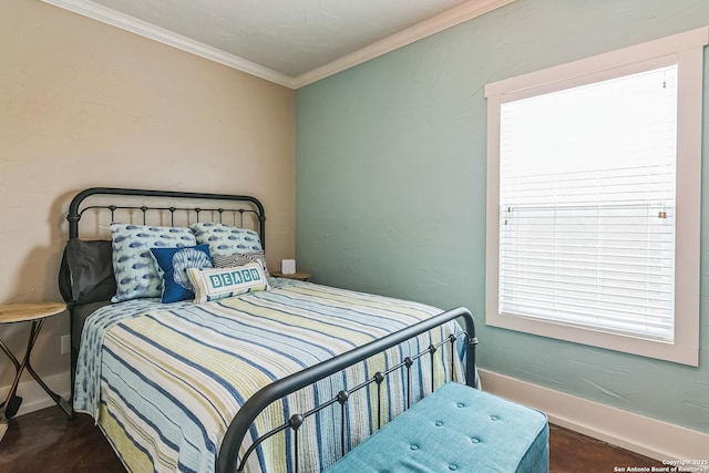 bedroom with crown molding and baseboards