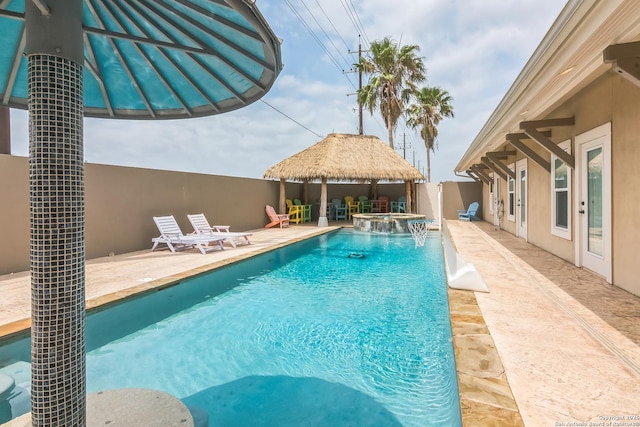 view of swimming pool with a patio, a gazebo, and a pool with connected hot tub