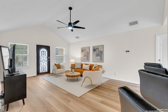 living area with ceiling fan, visible vents, baseboards, lofted ceiling, and light wood-style flooring