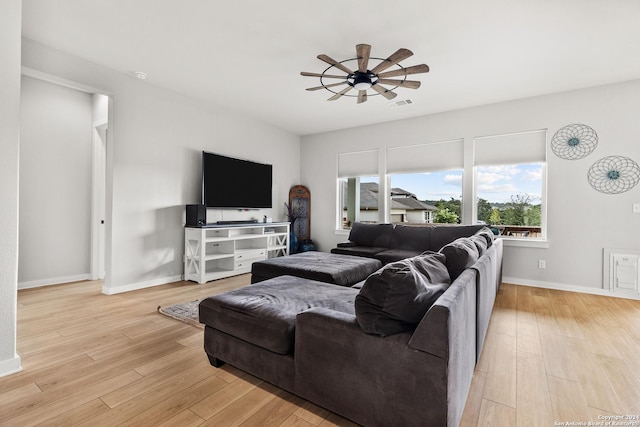 living room with light wood-style floors, a ceiling fan, baseboards, and visible vents