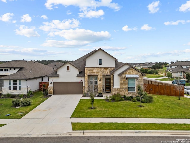 view of front of property featuring fence, stone siding, stucco siding, a front yard, and driveway