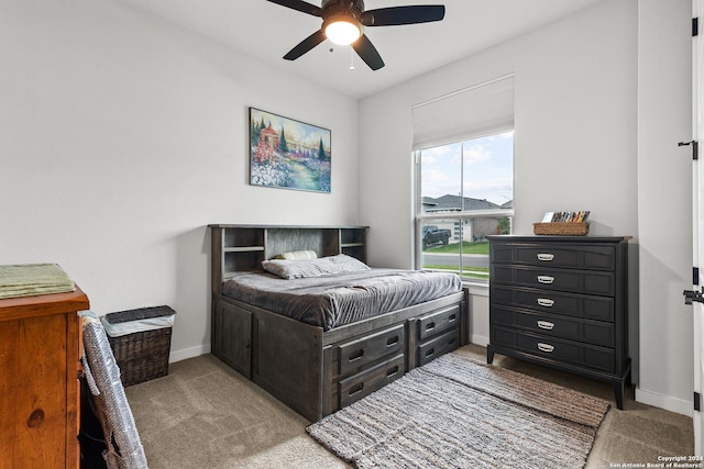 bedroom with baseboards, light colored carpet, and ceiling fan