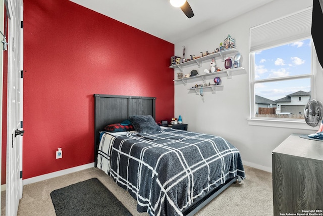 carpeted bedroom featuring baseboards and ceiling fan