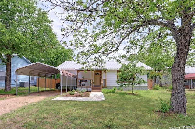 single story home featuring a front yard, central air condition unit, a carport, driveway, and metal roof