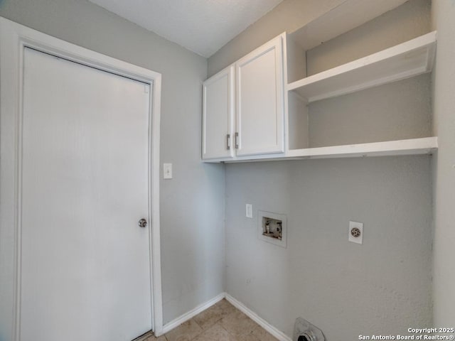 clothes washing area featuring washer hookup, electric dryer hookup, cabinet space, light tile patterned floors, and baseboards