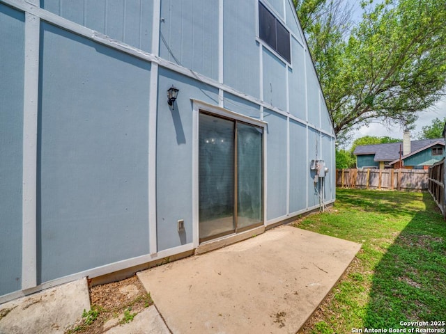 back of property featuring a yard, fence private yard, and a patio area