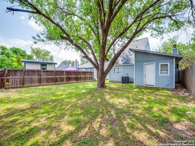 view of yard featuring central AC and a fenced backyard