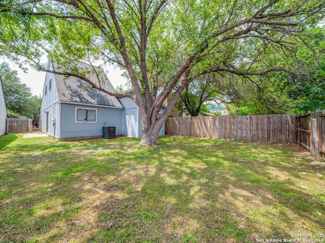 view of yard featuring central AC unit and a fenced backyard