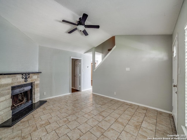 unfurnished living room with a stone fireplace, a ceiling fan, baseboards, lofted ceiling, and visible vents