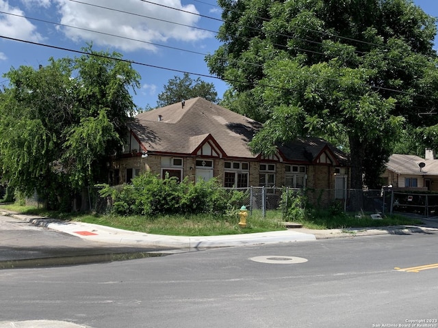 view of front of house featuring fence and stone siding