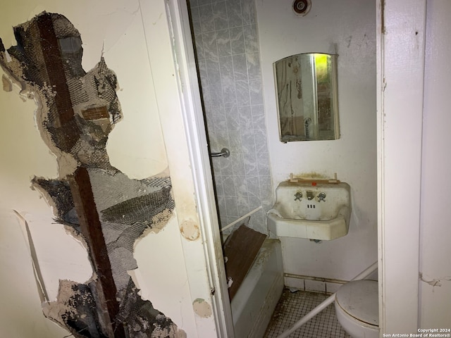 full bathroom with toilet, tile patterned floors, a sink, and a tub to relax in