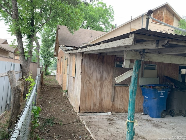 view of side of home with fence