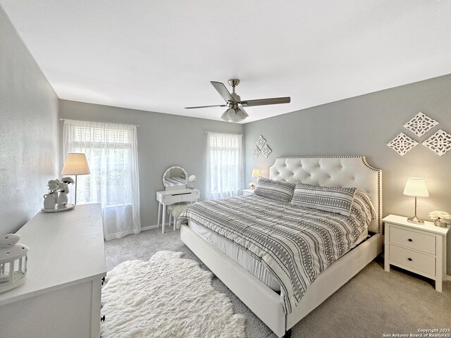 bedroom with ceiling fan, baseboards, and carpet