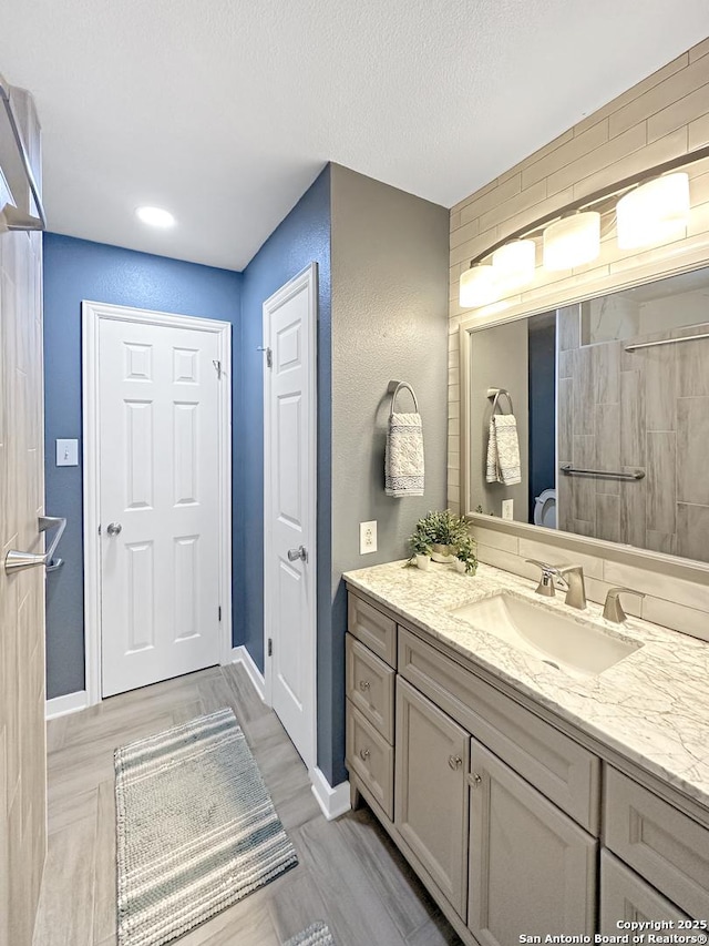 bathroom with baseboards and vanity