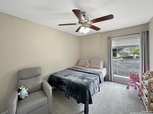 bedroom with ceiling fan and light carpet