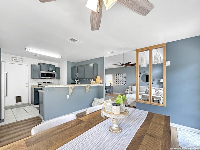 dining space featuring visible vents, baseboards, and ceiling fan