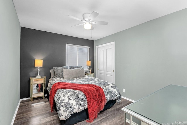bedroom with a closet, baseboards, and dark wood-type flooring