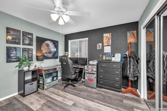 office area featuring baseboards, a ceiling fan, and wood finished floors
