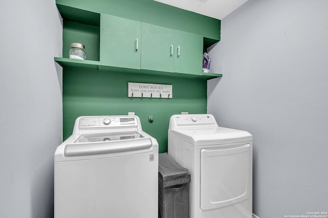 washroom featuring cabinet space and washer and dryer