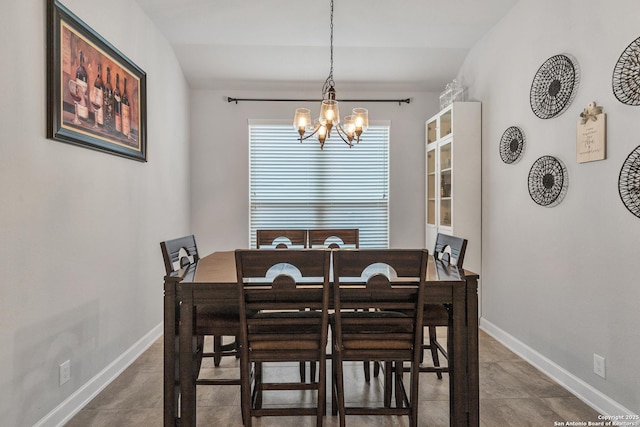 dining room with baseboards and a notable chandelier
