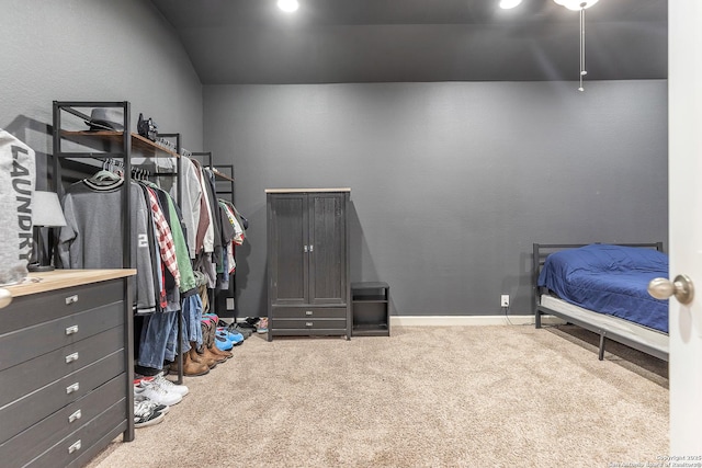bedroom featuring vaulted ceiling and carpet flooring