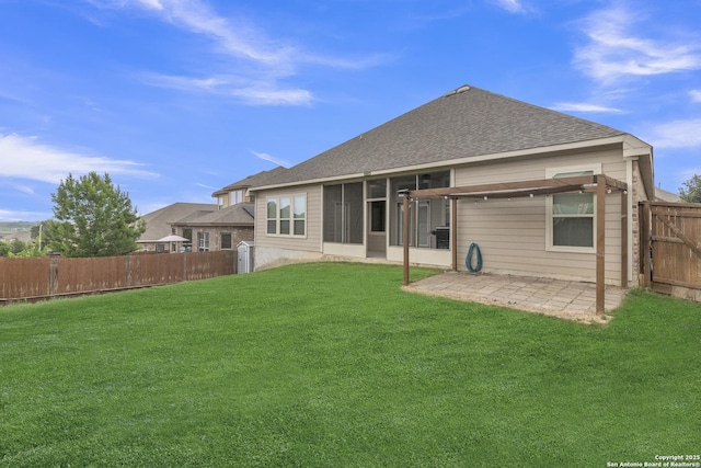 rear view of house featuring roof with shingles, a lawn, a sunroom, a fenced backyard, and a patio