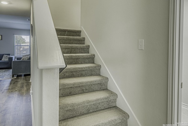 stairs featuring baseboards and wood finished floors
