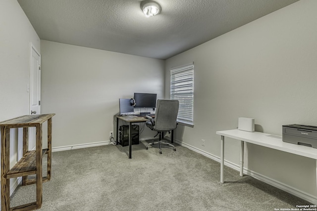 carpeted office space featuring baseboards and a textured ceiling