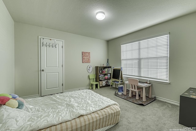 carpeted bedroom with baseboards