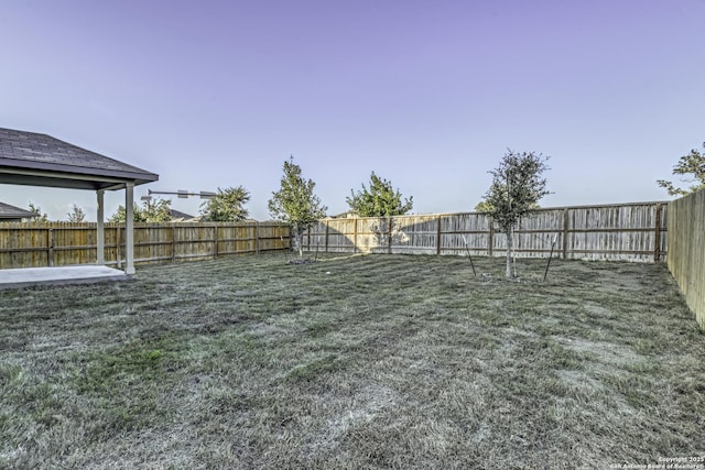 view of yard with a fenced backyard