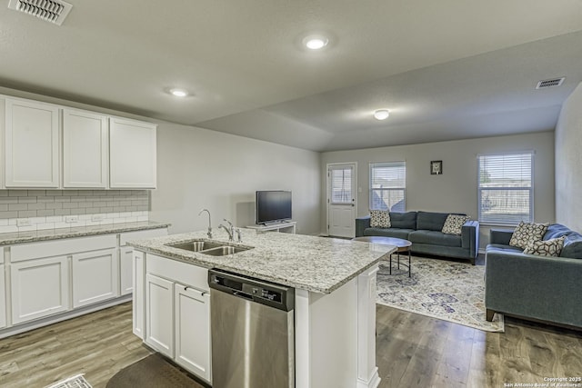 kitchen with visible vents, wood finished floors, dishwasher, a sink, and open floor plan