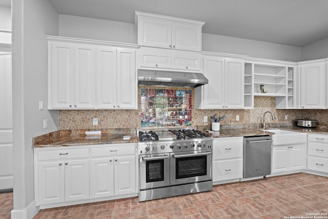 kitchen with open shelves, appliances with stainless steel finishes, dark stone countertops, white cabinetry, and under cabinet range hood