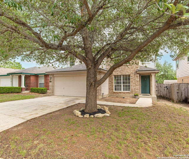 view of front of home with a front yard, a garage, brick siding, fence, and concrete driveway