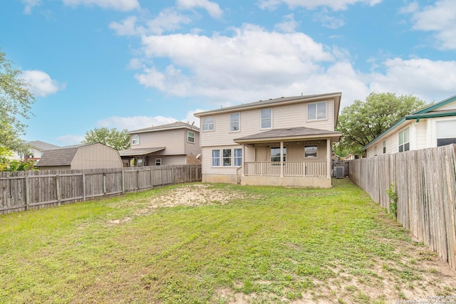 back of house featuring a lawn, a fenced backyard, and central air condition unit