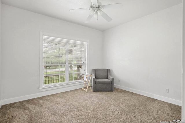unfurnished room with carpet floors, a ceiling fan, and baseboards