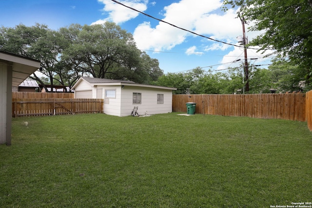 view of yard featuring a fenced backyard and a garage