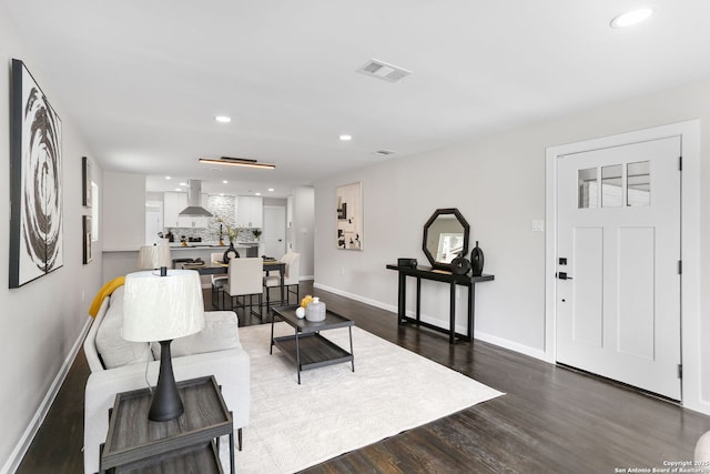 living room featuring visible vents, recessed lighting, baseboards, and dark wood finished floors