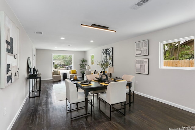 dining room featuring visible vents, baseboards, and dark wood-style floors