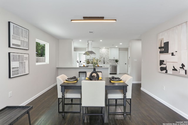 dining room with dark wood-style flooring, baseboards, and recessed lighting
